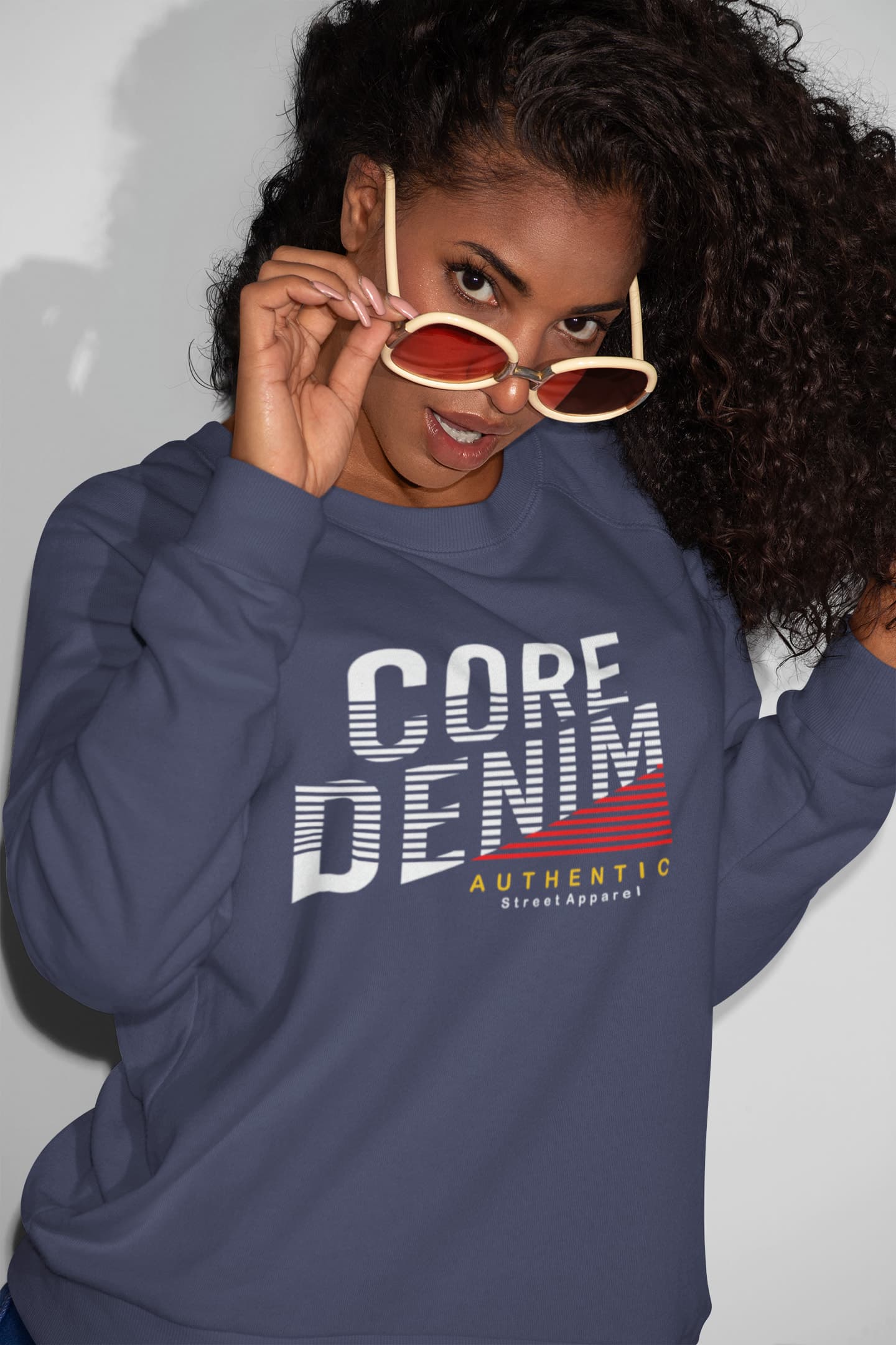 Person wearing a navy blue sweatshirt with &