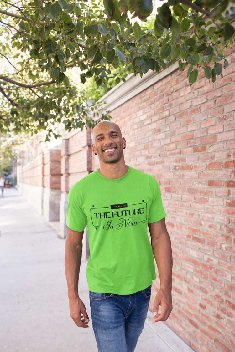 Man wearing a bright green t-shirt with text, standing outdoors against a brick wall.