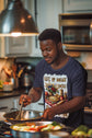 Man cooking in a kitchen with a colorful shirt