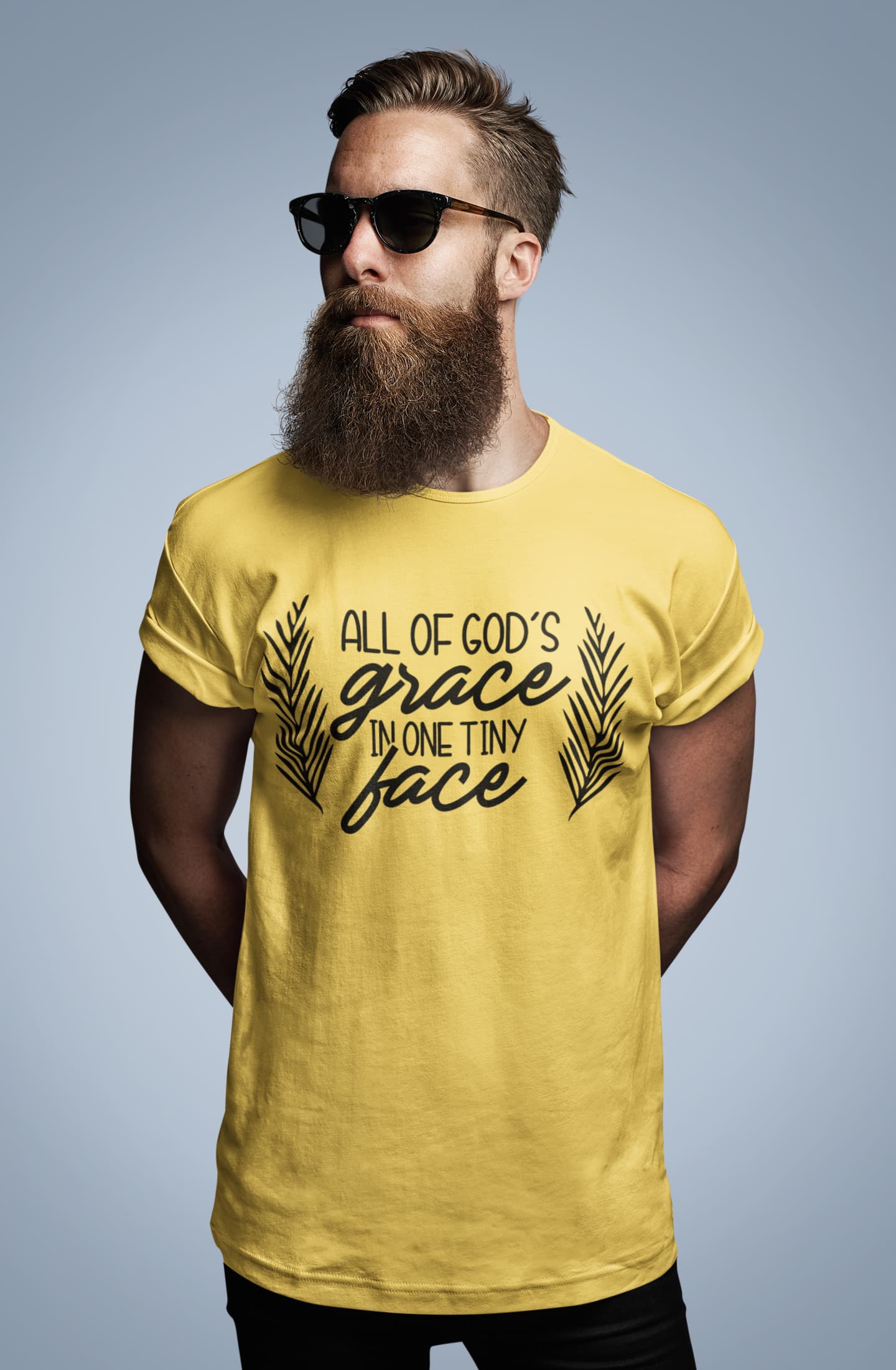 Man wearing a yellow t-shirt with text on a gray background