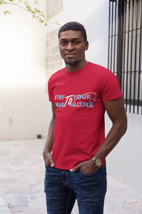 Man wearing a red t-shirt with text standing outdoors.