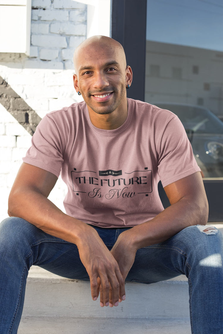 Man wearing a pink t-shirt with text sitting on steps outdoors.