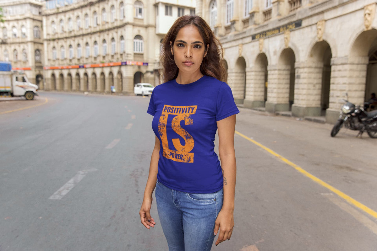 Woman wearing a blue t-shirt with text on a city street