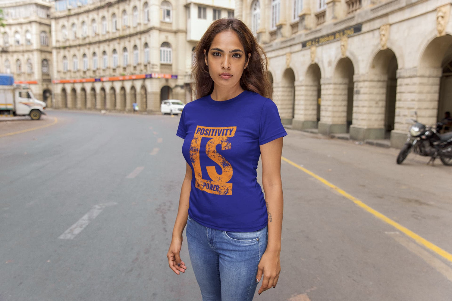 Woman wearing a blue t-shirt with text on a city street