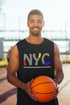 Man holding a basketball wearing a black sleeveless shirt with &