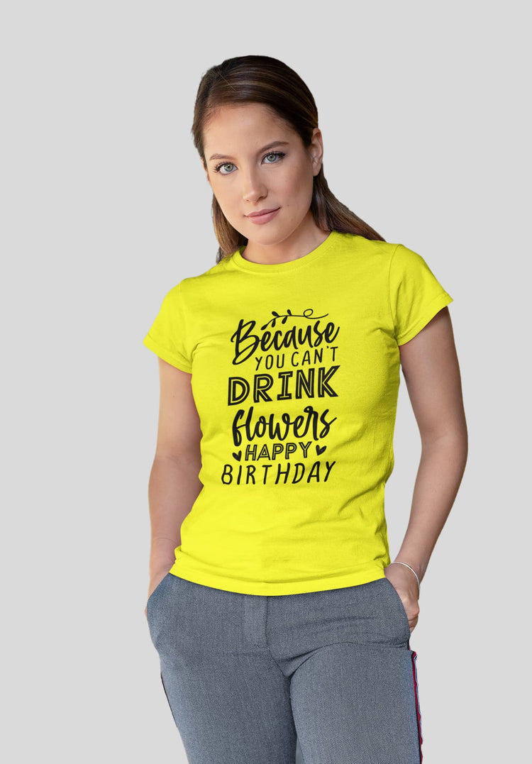 Woman wearing a yellow t-shirt with a humorous birthday message on a plain background