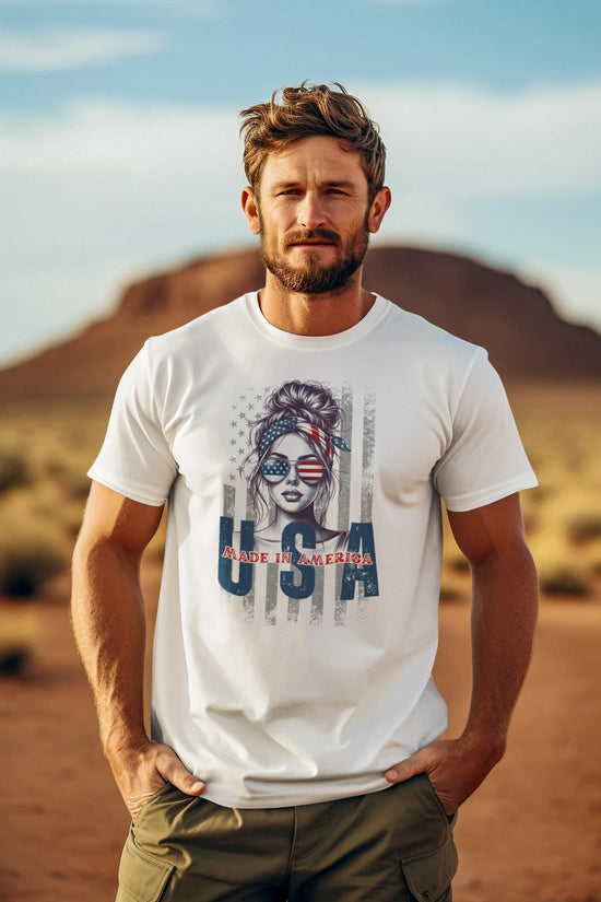 Man wearing a white t-shirt with a graphic design in a desert setting