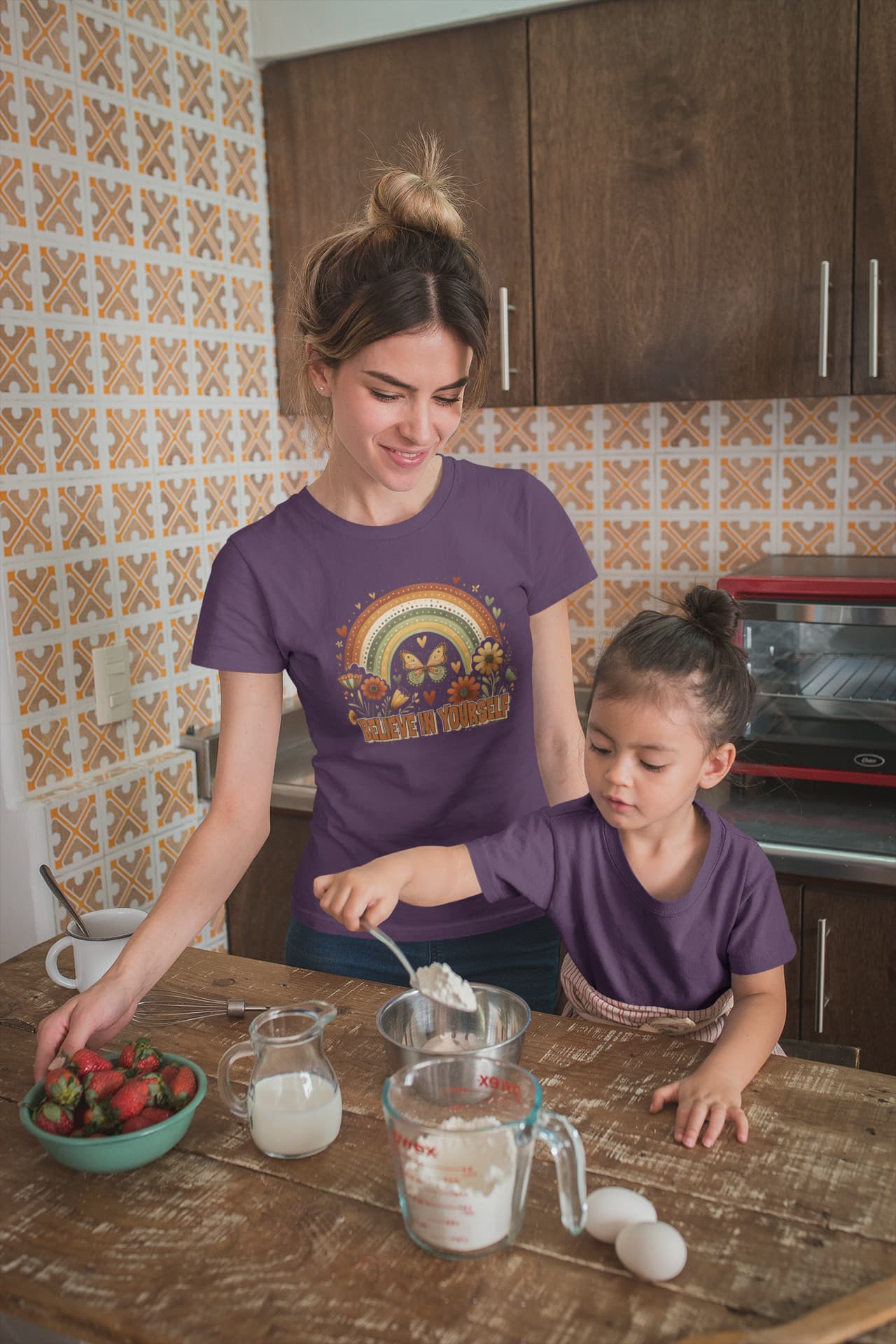 Woman and child in a kitchen preparing food together.