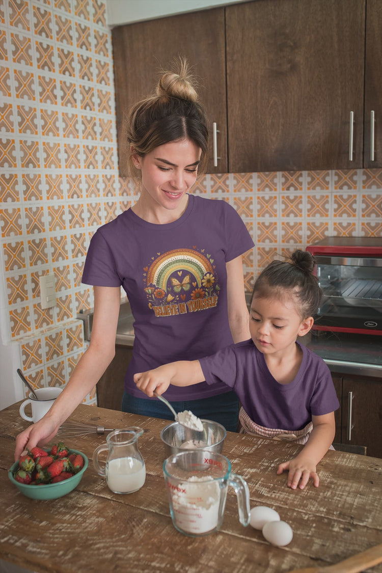 Woman and child in a kitchen preparing food together.